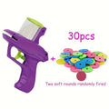 Green or purple plastic cat toy launcher with soft foam discs for interactive play.