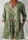 A woman modelling a printed, loose-fitting dress with a wide waist and three-quarter length sleeves.