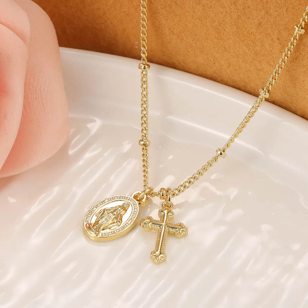 Gold Virgin Mary necklace with geometric cross pendant on copper chain