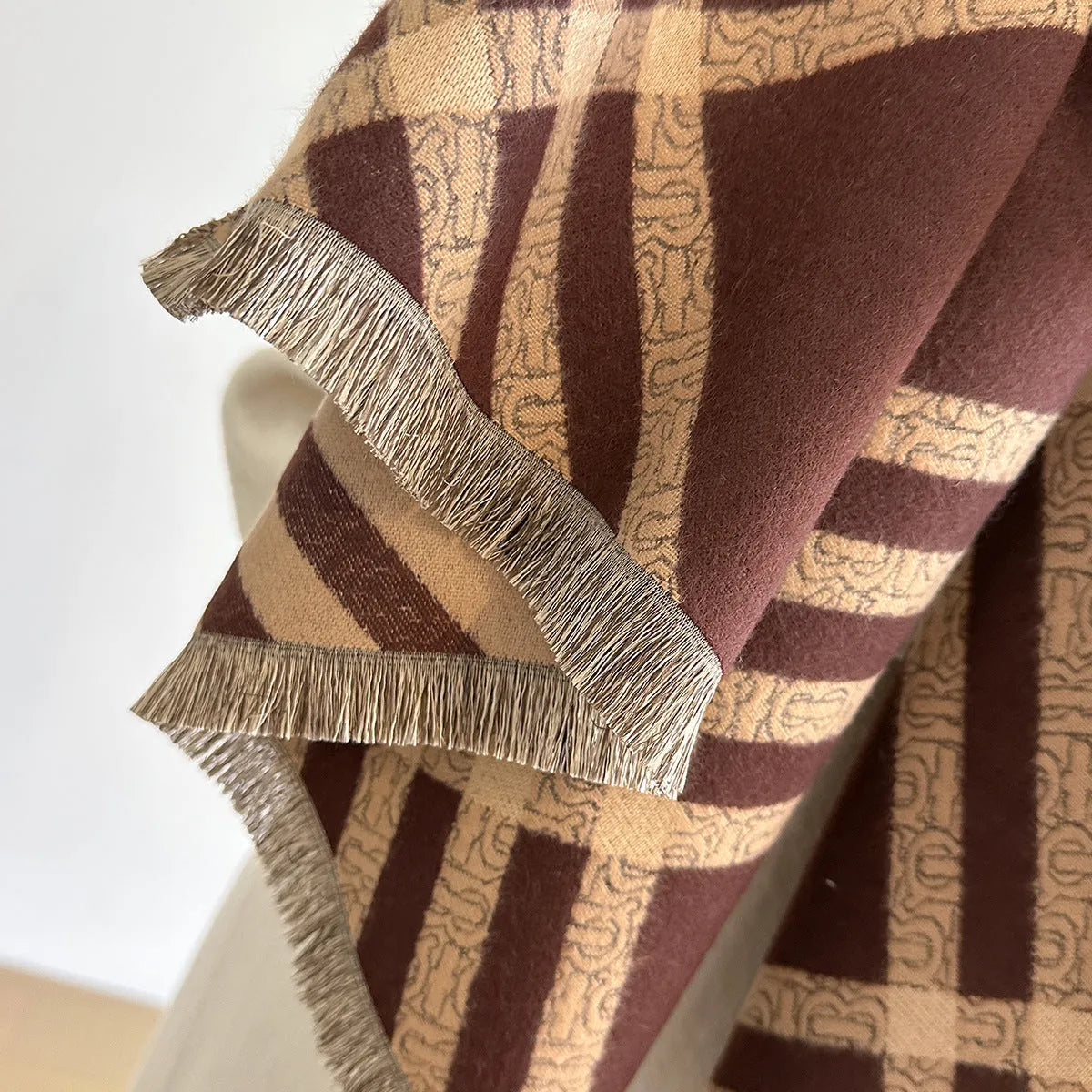 Cashmere-like scarf with tassel detailing in brown colour showing mid-length design