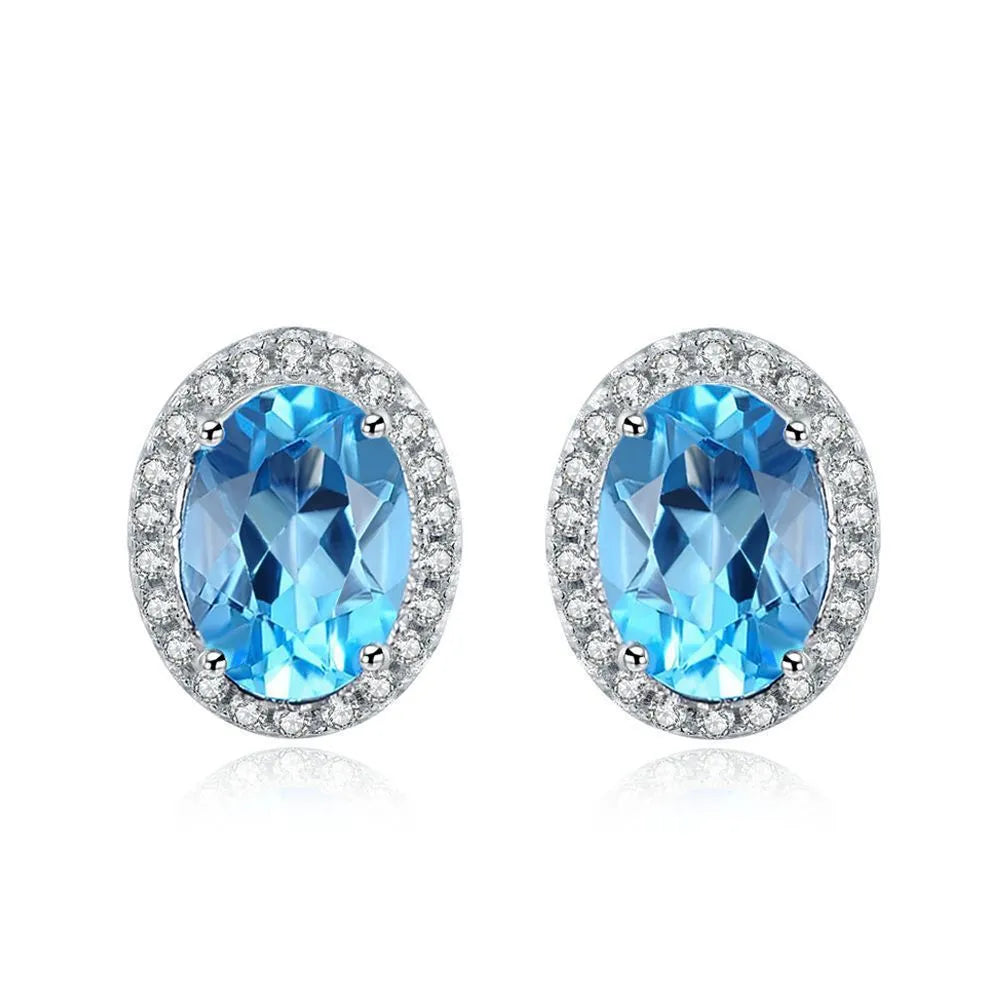 Four-piece 925 sterling silver jewellery set with blue topaz stones: geometric necklace, earrings, ring, and pendant.