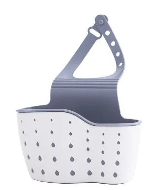 Set of three plastic kitchen sink storage racks in light blue, light pink, and beige on a countertop