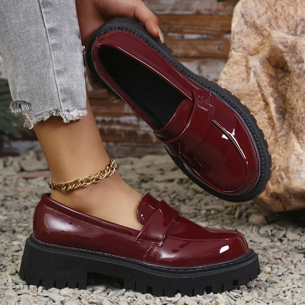 Plus size women's slip-on loafers in black with a chunky platform heel and rubber sole.