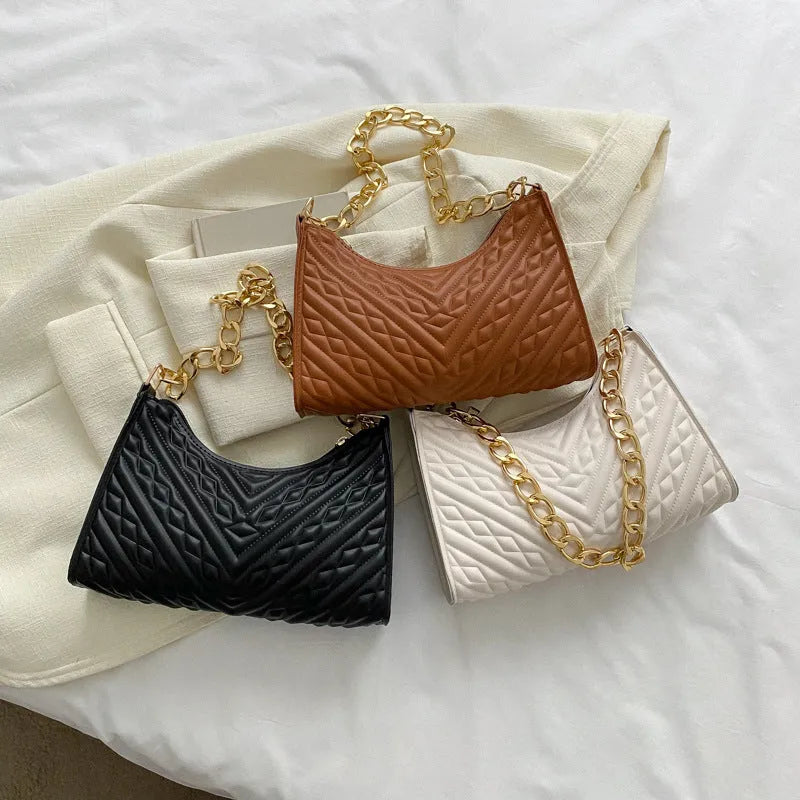 Brown pleated chain shoulder bag showing vertical square shape and adjustable strap