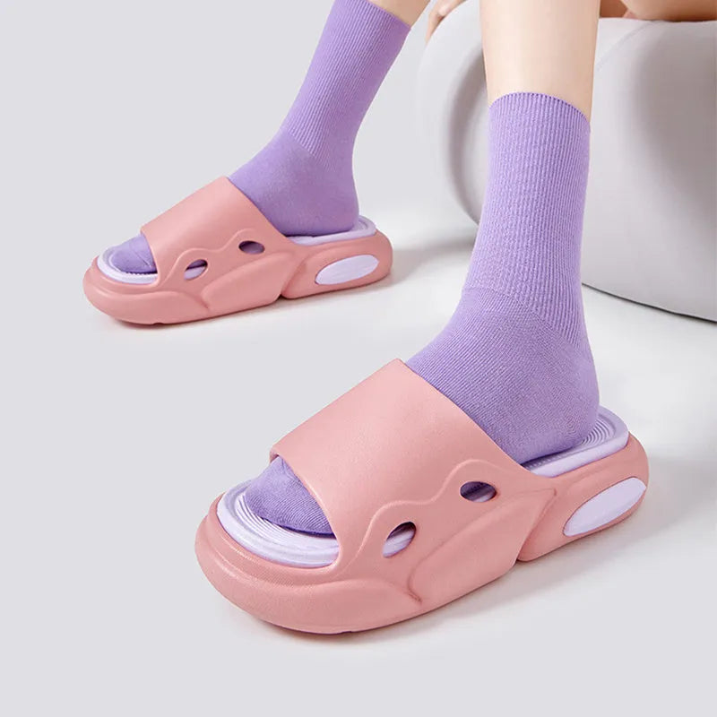 Two-colour EVA couples slippers with thick sole and leather lining in pink purple, shown from the side.