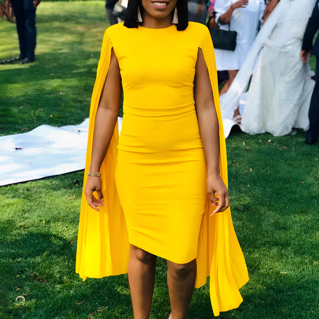 Women's long sleeve yellow evening gown with high waist and attached pleated shawl detail