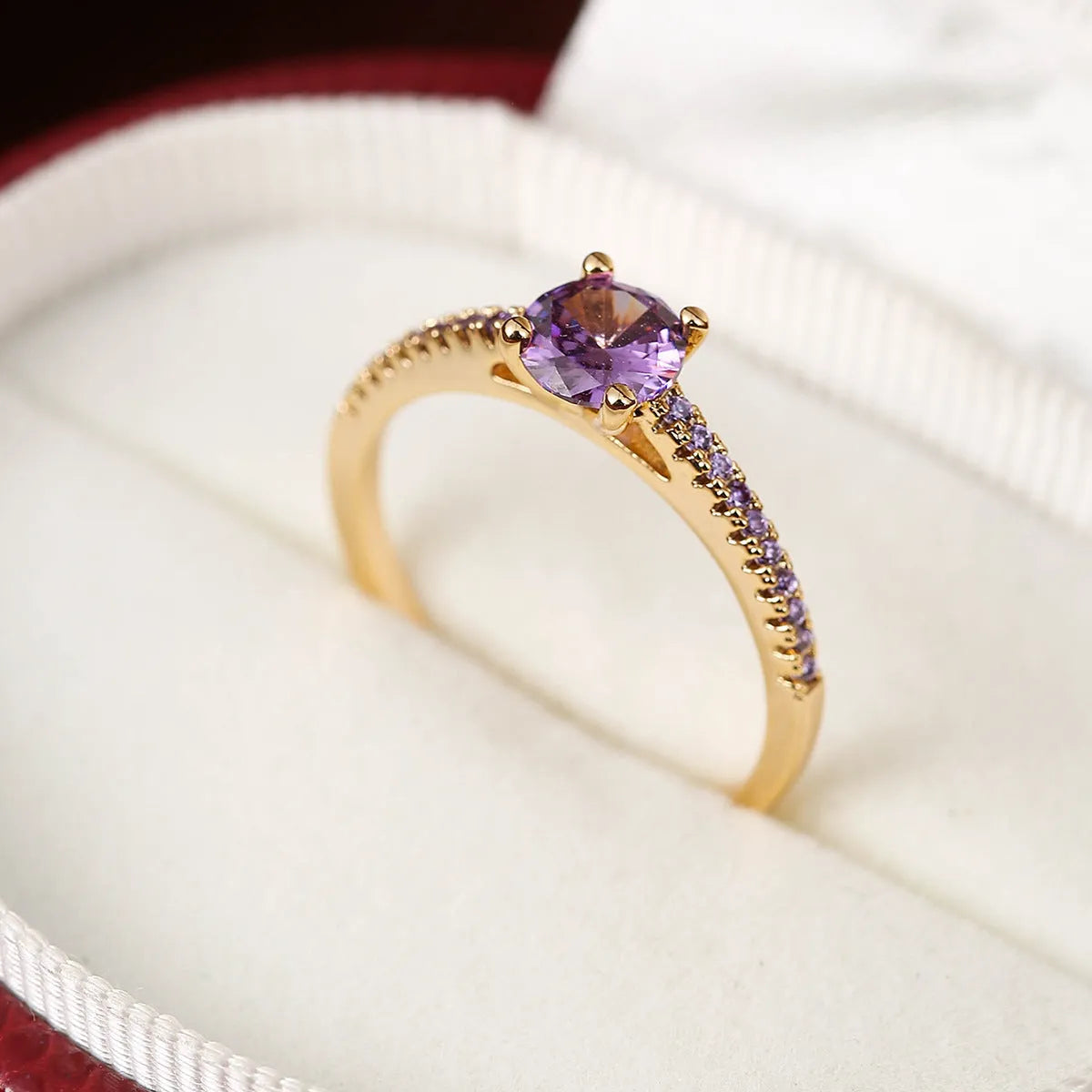 Geometric hexagon copper ring with colourful zircon stones in a metallic electroplated finish.