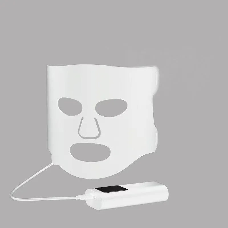 Black and gold LED phototherapy face mask with controller for home skin treatment.