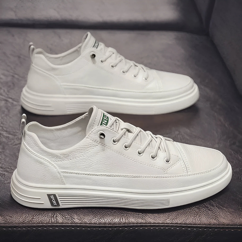 Men's casual white shoes with round toe and flat low-heel sole on a plain background.