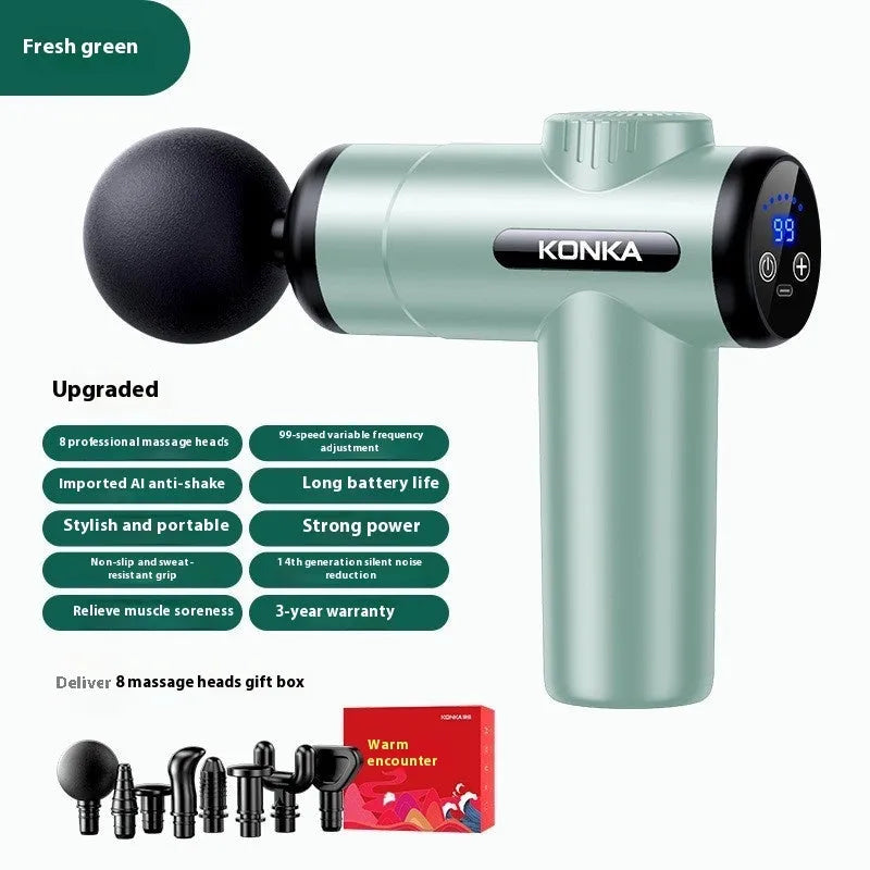 Konka V19 grey mini electric massage gun with multiple attachment heads on a table