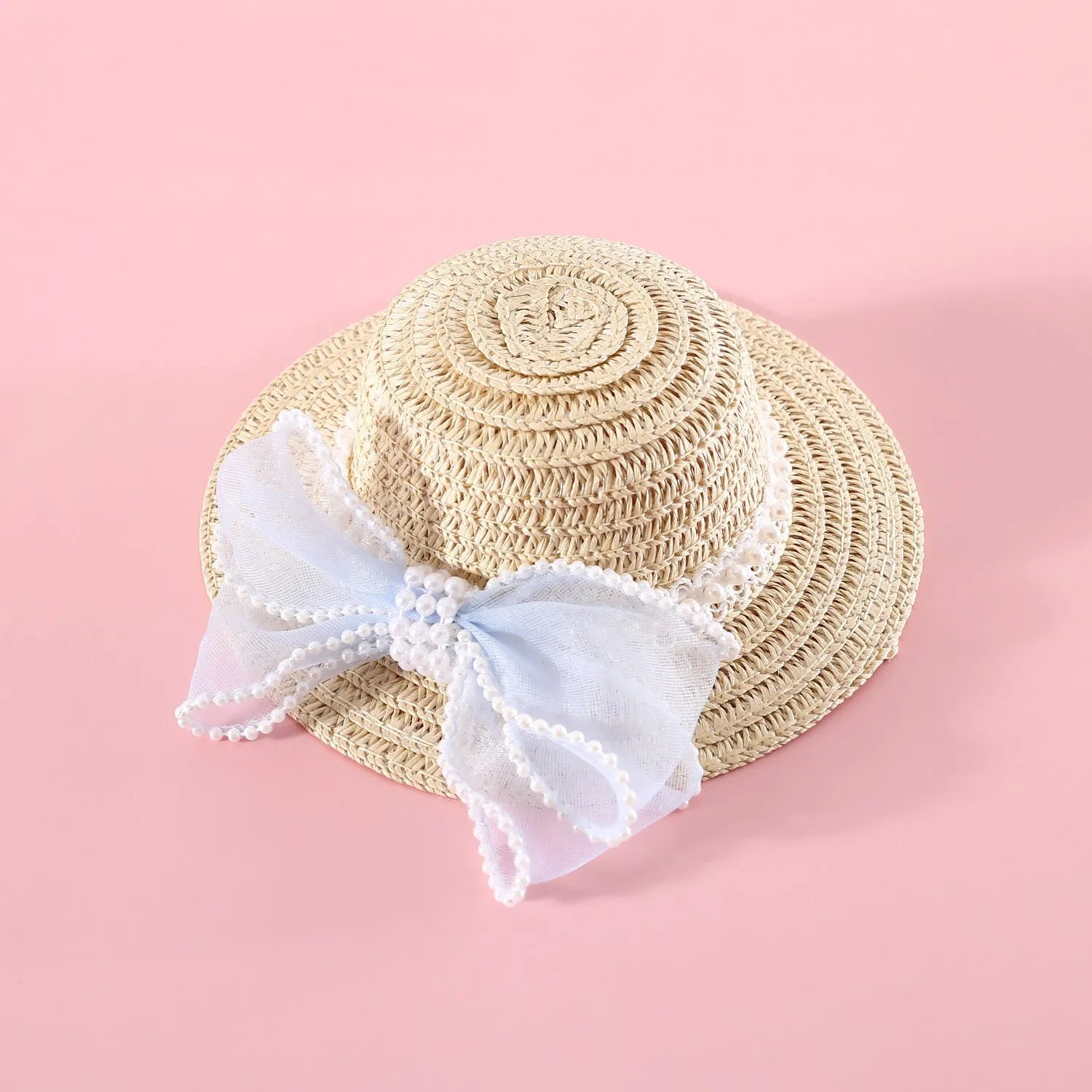 Woven straw hat for a cat with a pearl butterfly bow, shown in pink, purple, blue, or white colour options.