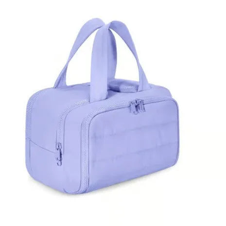 Large open-top travel toiletry bag in black polyester with fluffy texture, showing ample storage space.