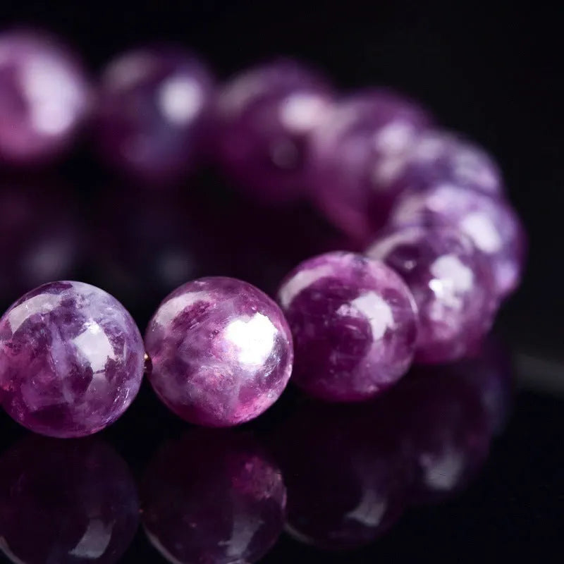 Grandmother Crystal bracelet with purple geometry-shaped beads on a wrist.