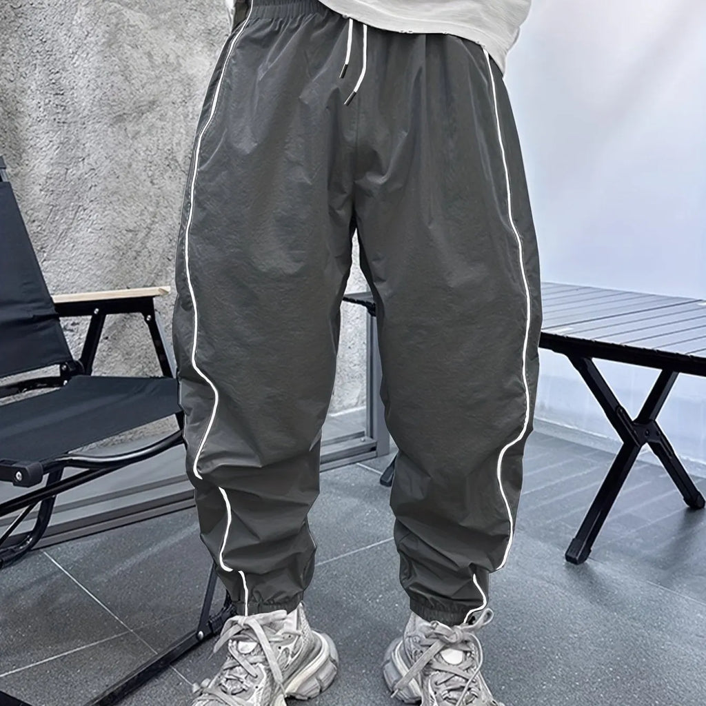 Men's loose blue bamboo fibre cropped sports trousers on a grey background