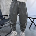 Men's loose blue bamboo fibre cropped sports trousers on a grey background