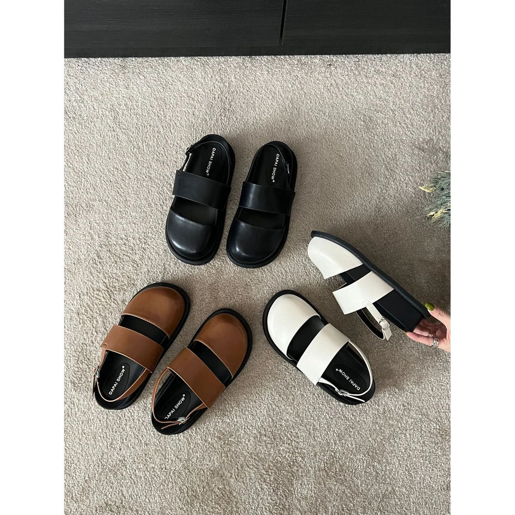 Retro style closed toe sandals with a single ankle buckle strap in apricot colour.