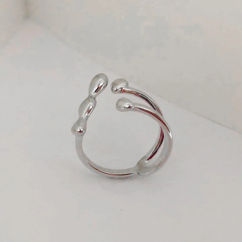 Adjustable brass opening ring with circular sphere element in gold or silver finish