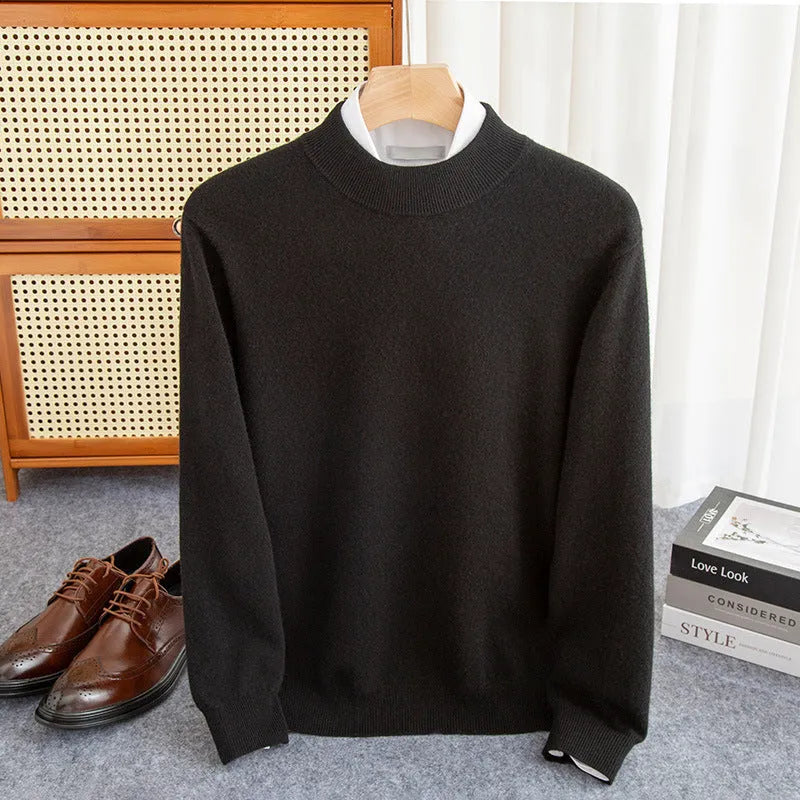 Man wearing a loose-fit, chunky knit wool sweater with a half-turtleneck collar in a neutral colour.
