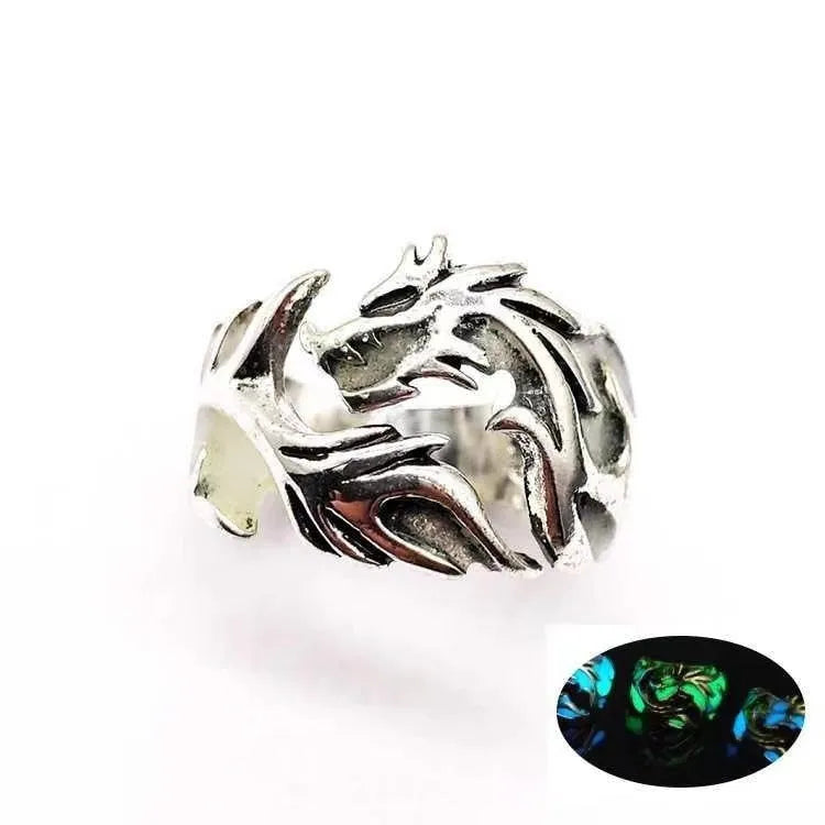 Close-up of an adjustable silver blue and green metal ring with a Chinese dragon pattern.