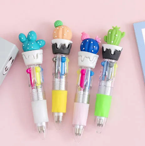 A cartoon-themed press-type ballpoint pen showing four-colour cartridge and a random print design on a silicone and plastic barrel.