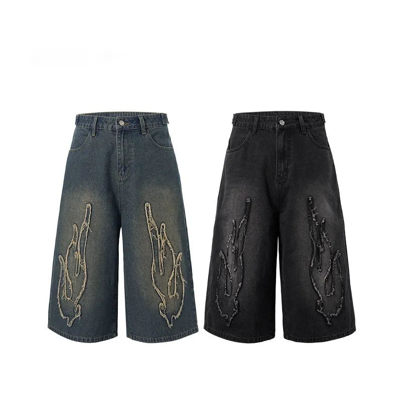 Men's black denim shorts with flame embroidery patch on leg, cropped straight cut style