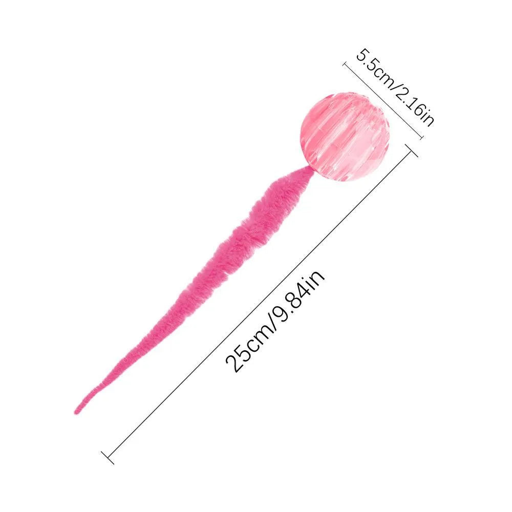 Interactive cat toy with purple bouncy ball and plush tail on wooden floor