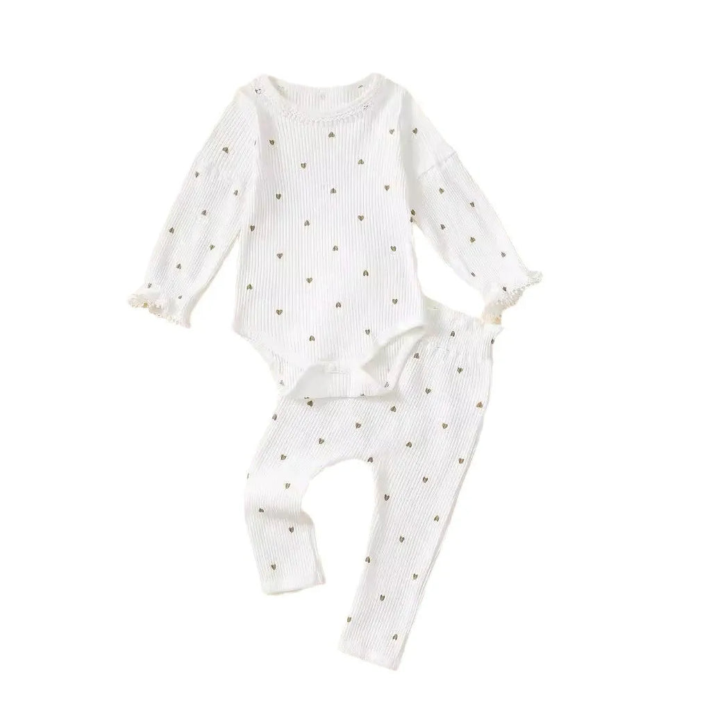 White cotton baby suit three-piece set with top, long pants, and hair tie showing sunken stripe stitching