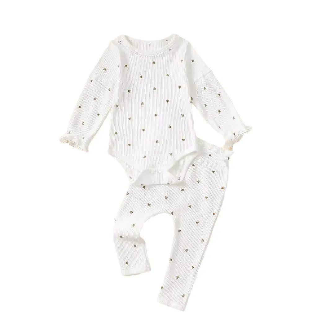 White cotton baby suit three-piece set with top, long pants, and hair tie showing sunken stripe stitching