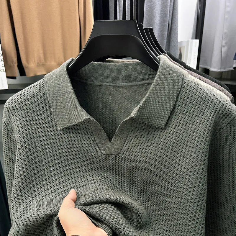 Men's loose green pullover sweater on a hanger, casual autumn wear.