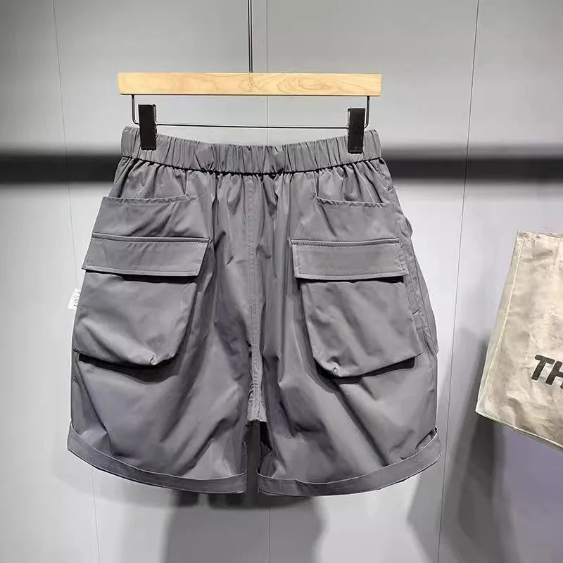 Men's loose fit work shorts in black or grey with pockets and non-iron treatment