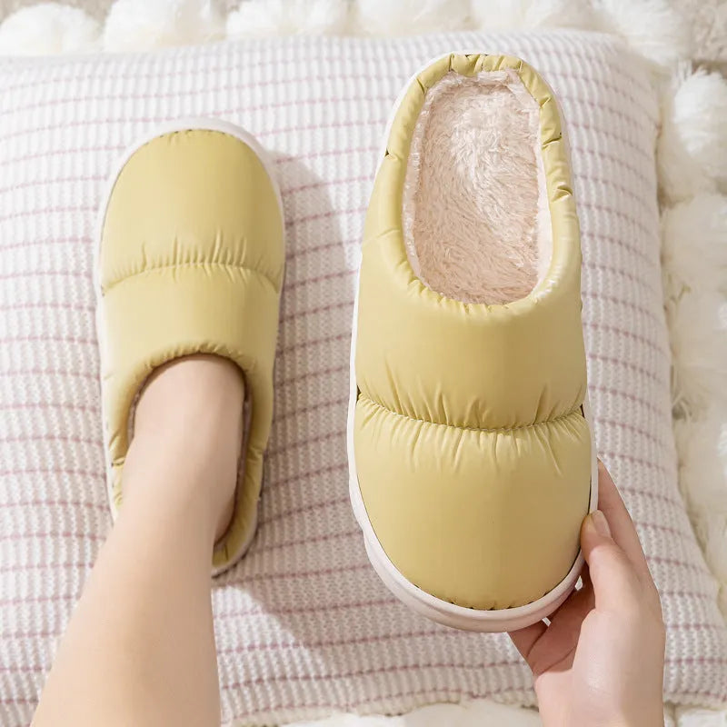 Pair of thick-soled winter slippers with artificial leather upper and plush lining, shown in a choice of colours.