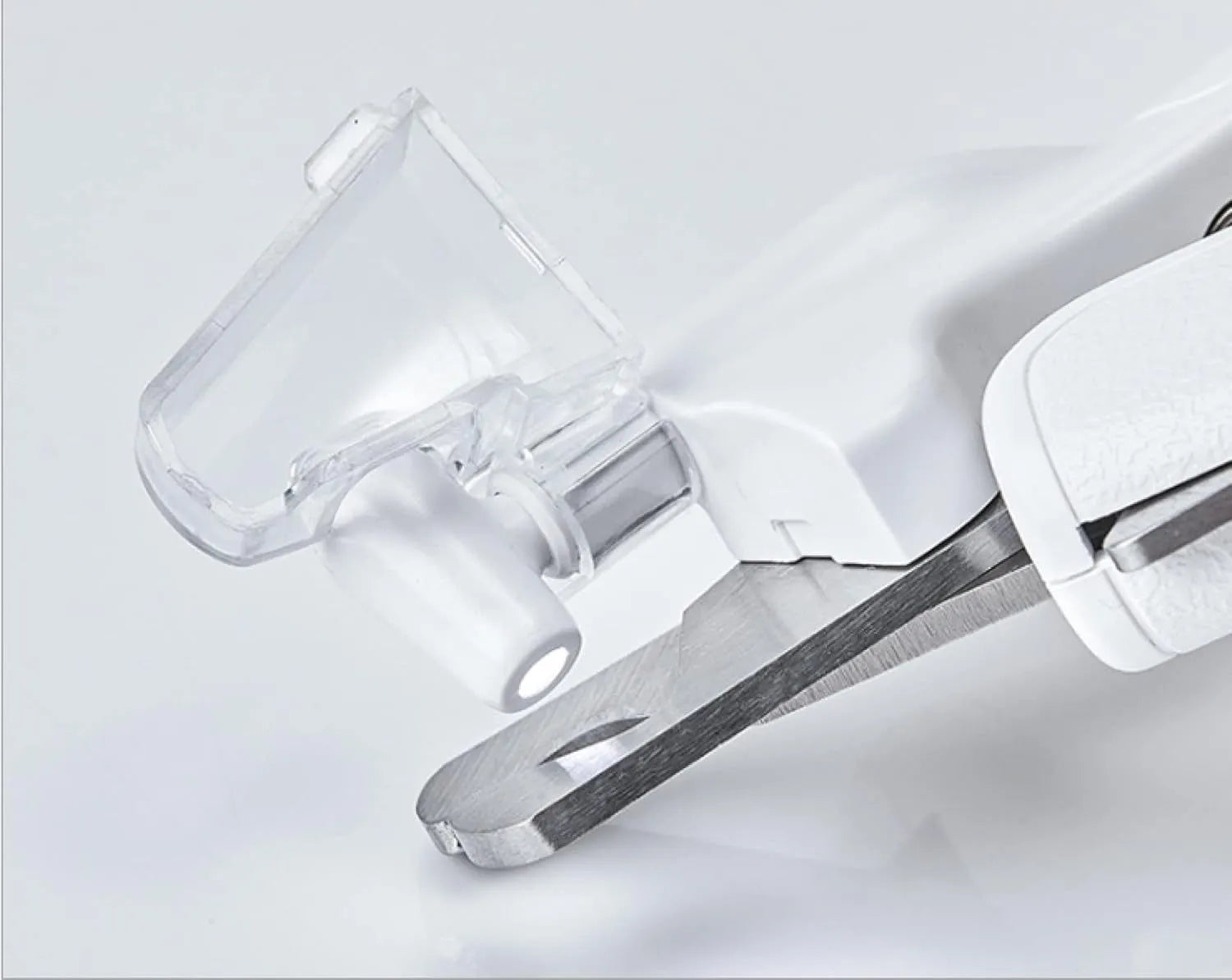 White pet nail clippers with LED light, transparent splash guard, and anti-slip handle.
