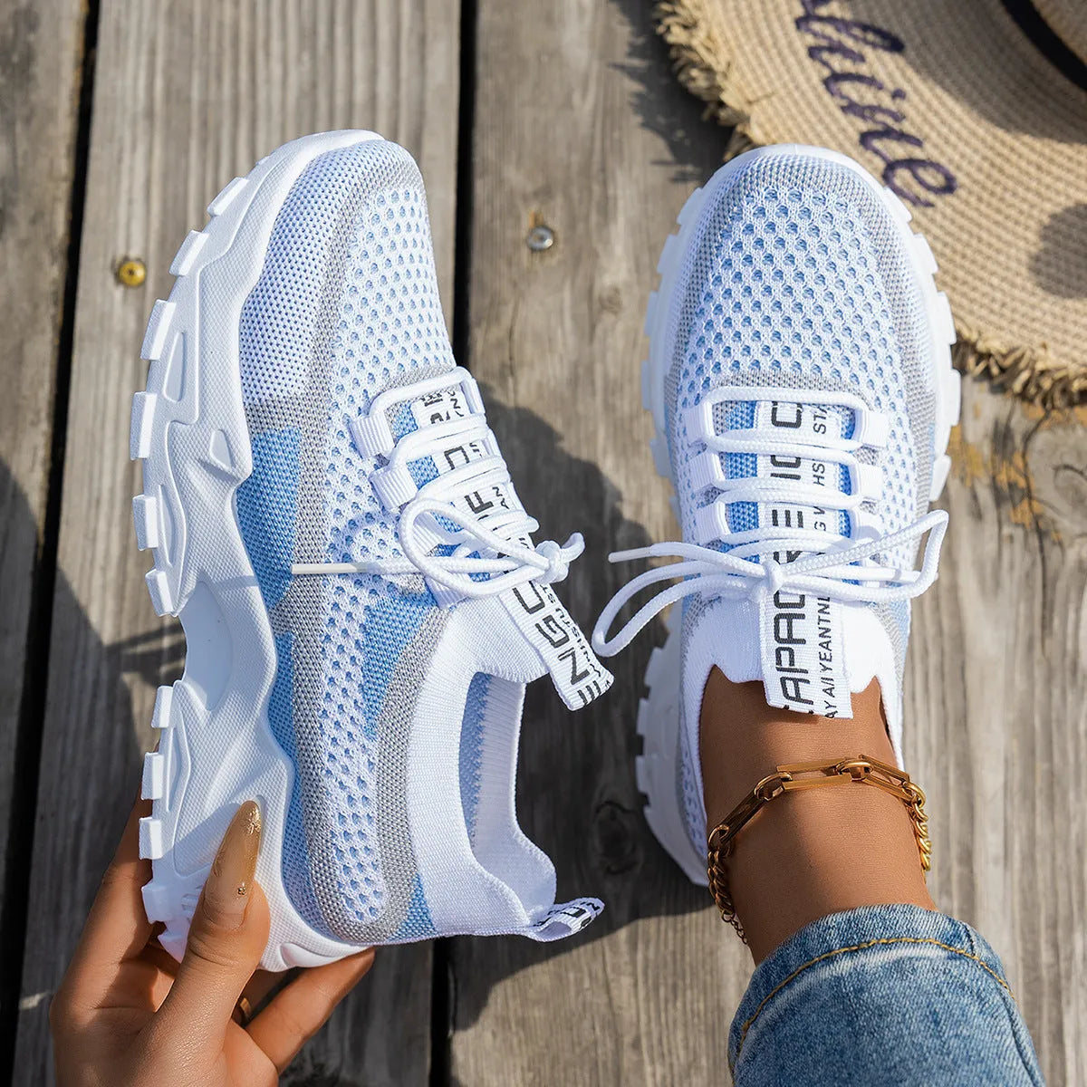 Women's Flyknit mesh lace-up sneaker in a grey colourway, showing the breathable upper and rubber sole.
