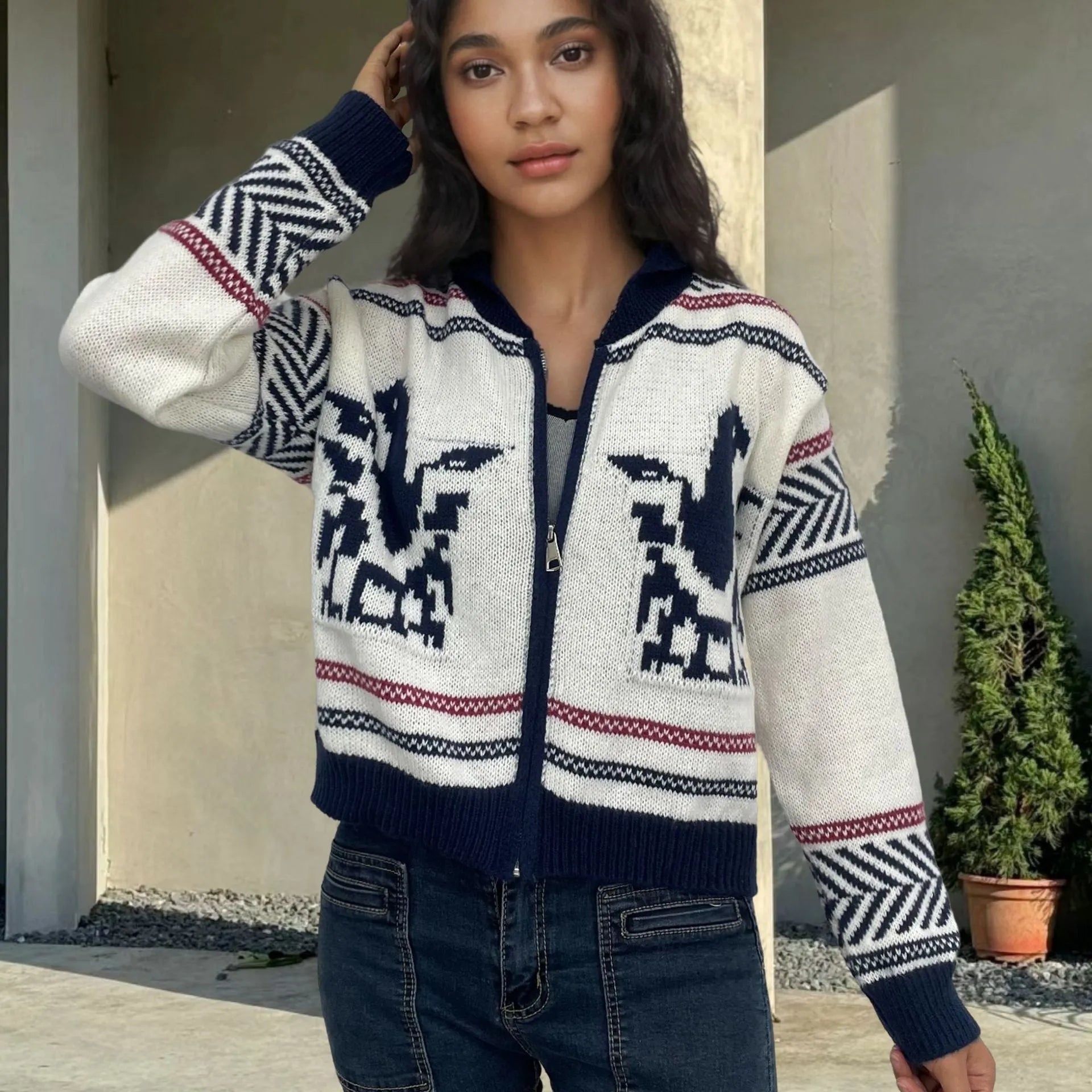 White women's cardigan with a front zip, lapel collar, and jacquard contrast colour striping.