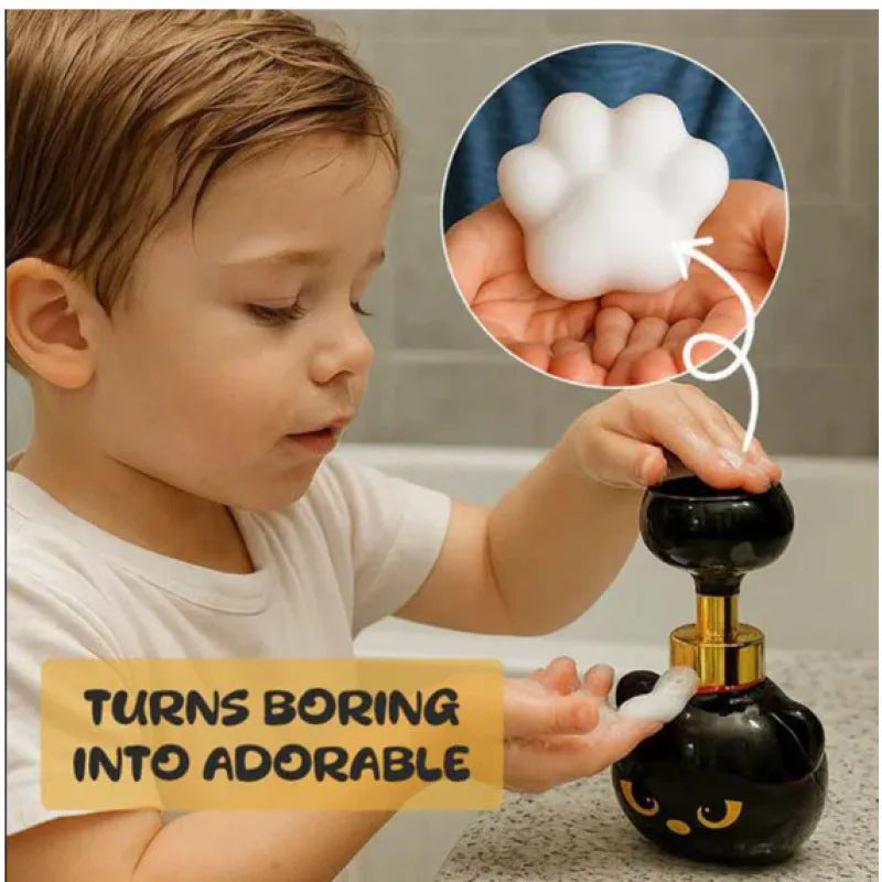 Black plastic cartoon cat-shaped foam soap extrusion dispenser on a bathroom countertop.