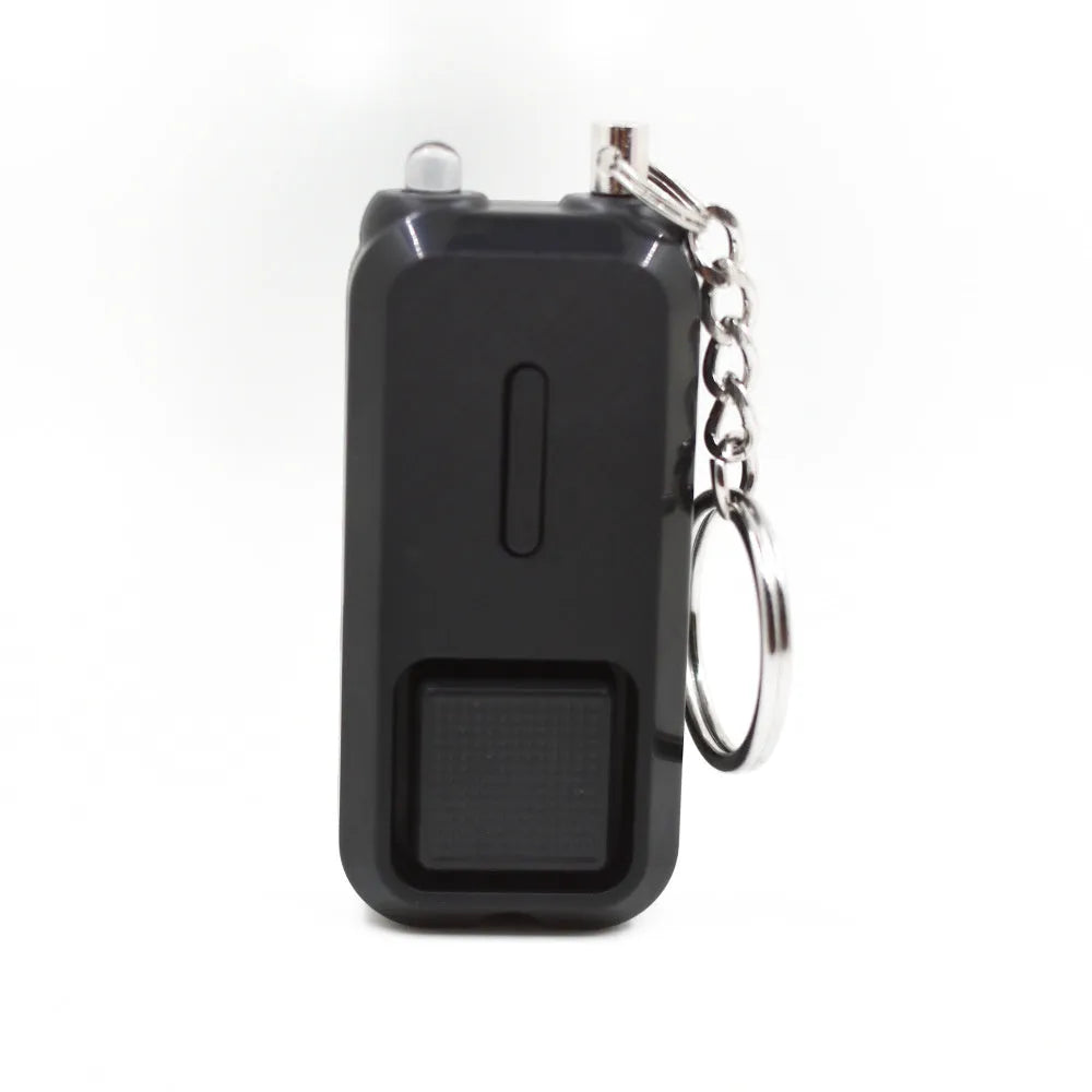 Compact pink personal safety alarm with keyring, showing dimensions next to a ruler.
