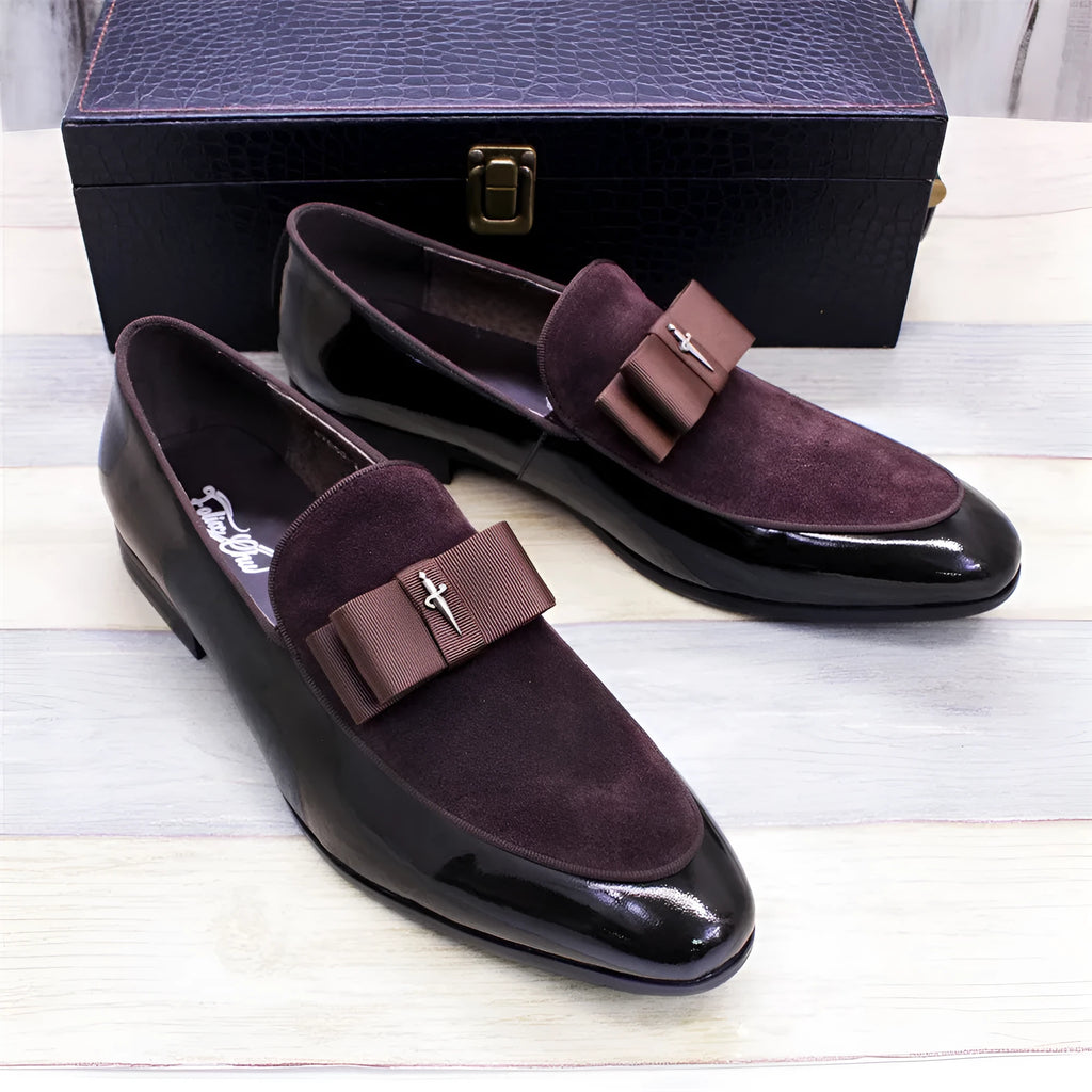 Men's black patent leather low-top dress shoes with a tassel detail on the front.