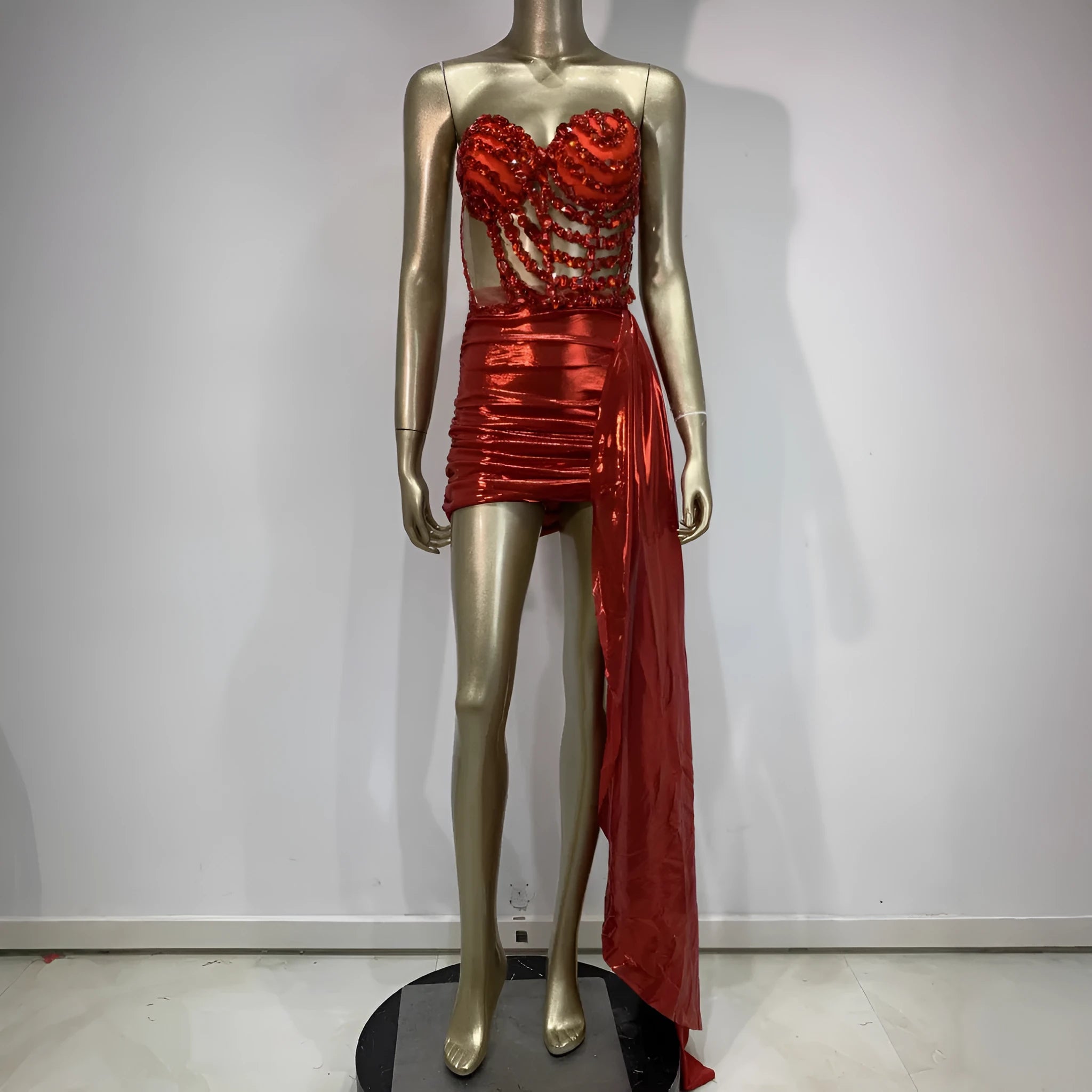 Red women's skirt suit with see-through mesh panels, made from stretch spandex fabric.