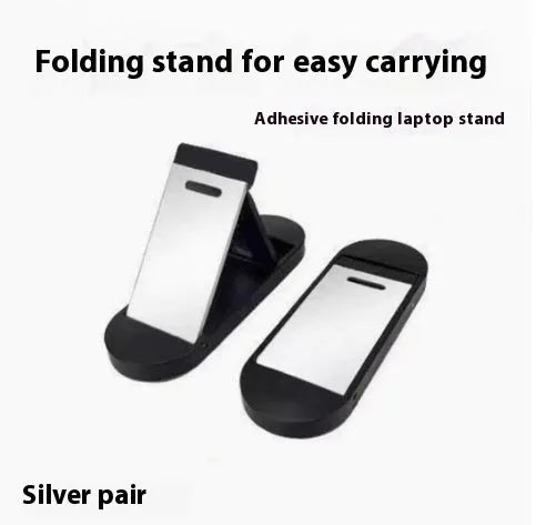 Compact silver aluminium folding laptop stand on a desk next to a wireless keyboard.