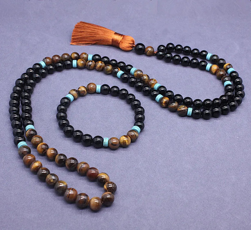 Black geometric agate bracelet and necklace set on a display background.