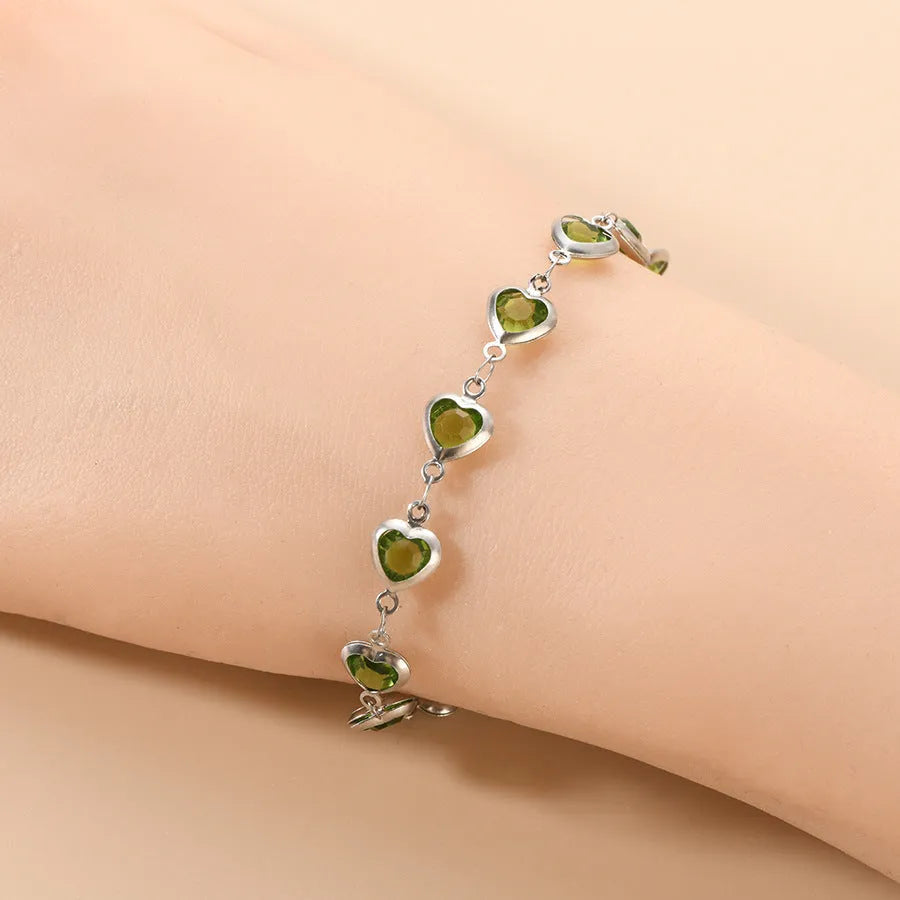 Devil's Eye geometric heart bracelet in stainless steel, shown in colourful, blue, green, and red finishes.