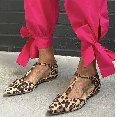 Leopard print women's pumps with cross shoulder straps and a chunky low heel