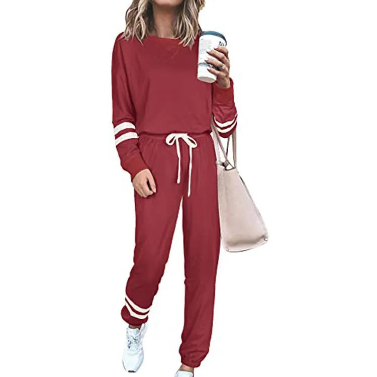 Women's loose-fitting casual suit set in a solid colour, comprising a long-sleeve top and matching trousers.