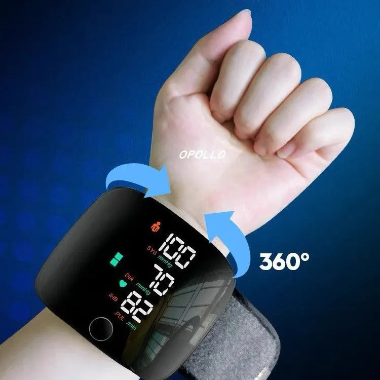 Black wrist blood pressure monitor with digital display and USB charging port.
