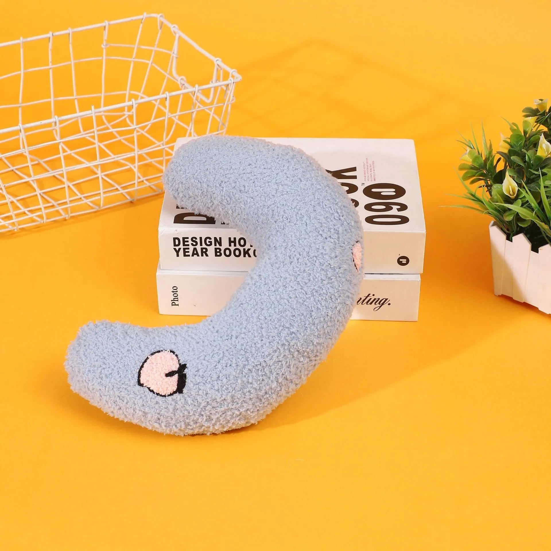 Blue half moon U-shaped cat pillow with cartoon dog and cat design for pet crates.