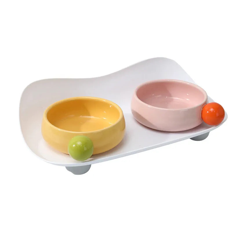 Double raised ceramic pet feeding bowl set with non-slip base in pink colour