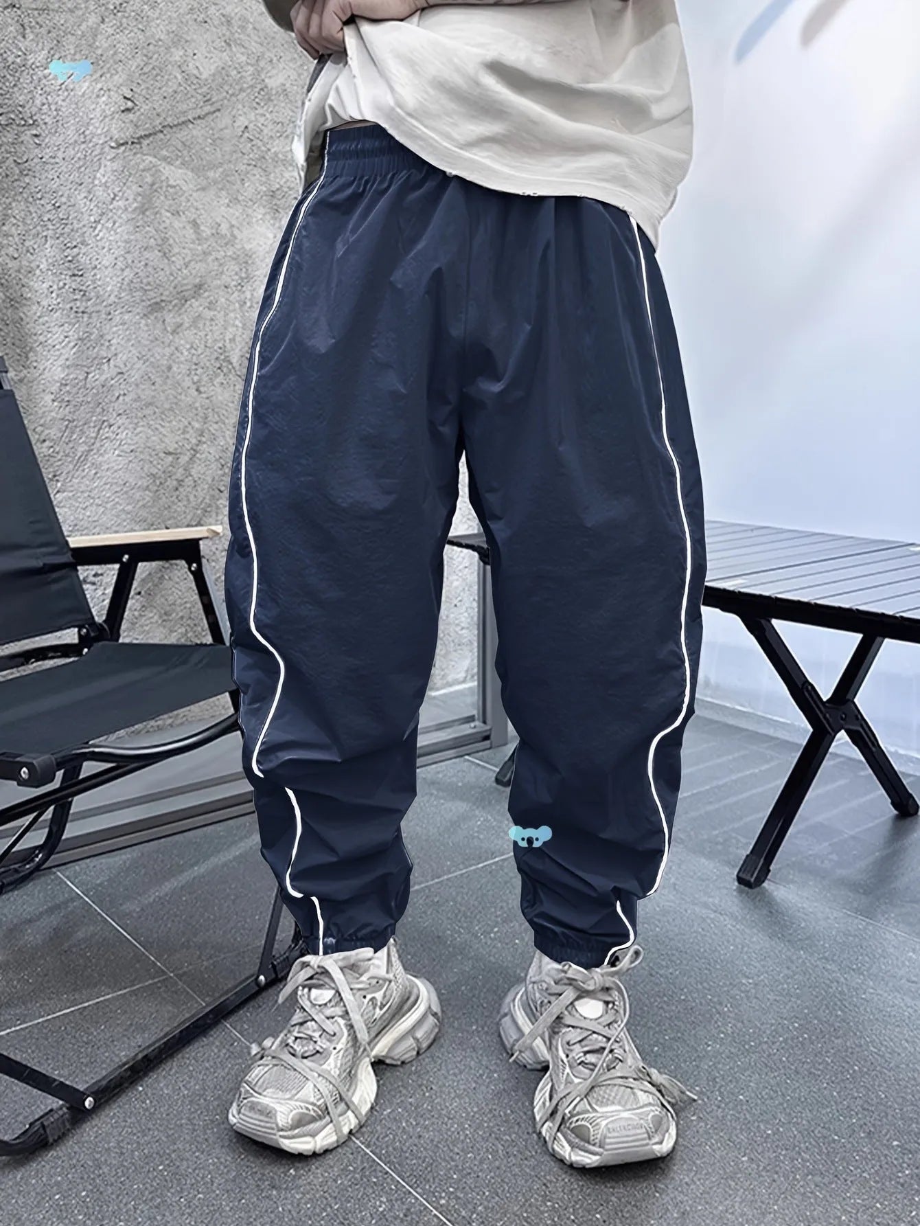 Men's loose blue bamboo fibre cropped sports trousers on a grey background