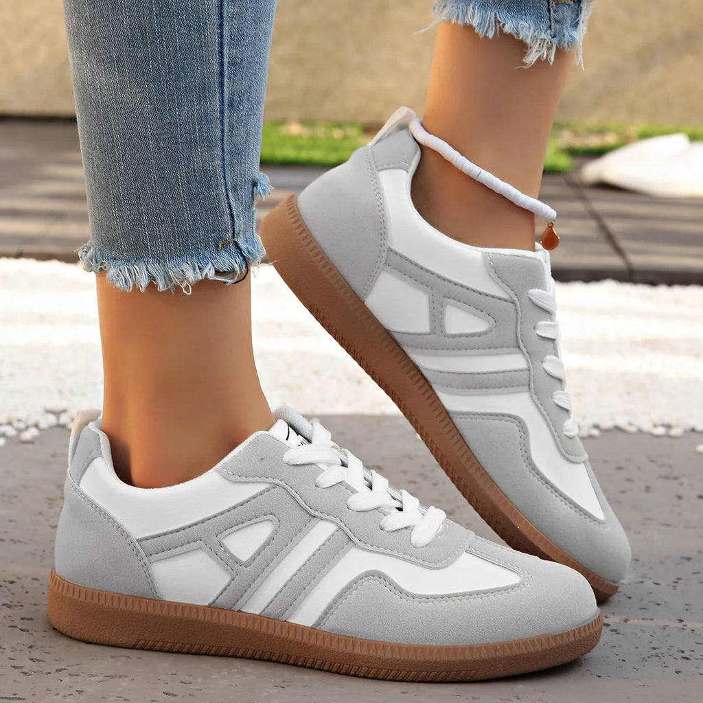 Women's retro grey jogging shoes with lace-up front and cross-strap detail on a rubber platform sole.