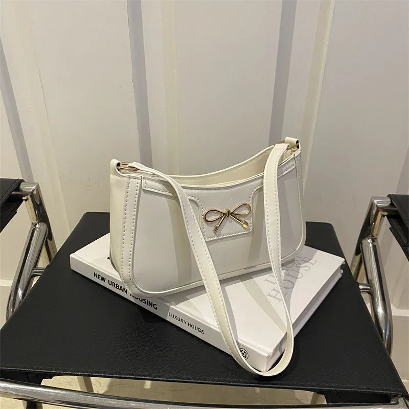 Western style baguette shoulder bag with bow detail showing horizontal square shape