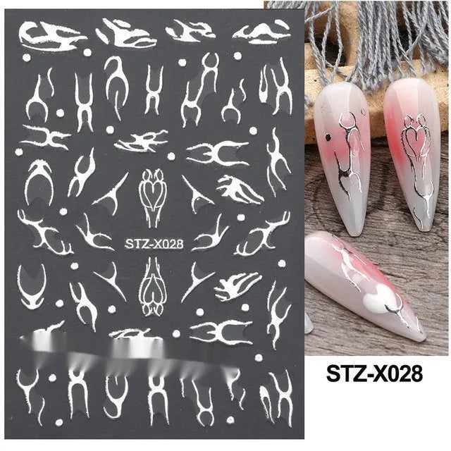 Close-up of a cartoon-style nail sticker with black and silver strips and a love pattern design on a fingernail.